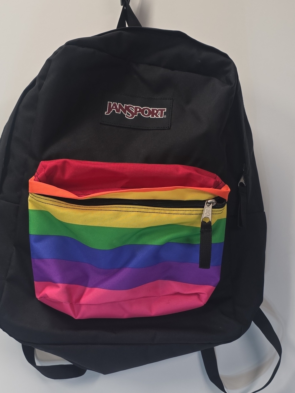 JanSport Black Backpack with Rainbow Front Pocket